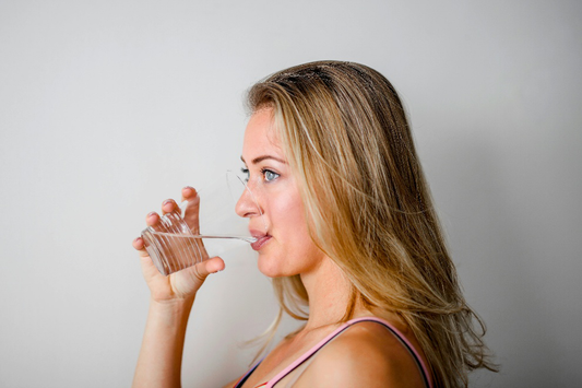 A woman drinking water from a glass
